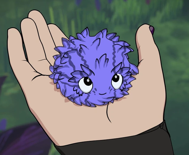 A round, fluffy purple Adoraburr sitting in an open palm